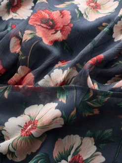 Bleu marine à fleurs - Robe longue imprimée à col haut et à volants